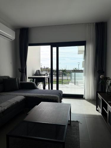 a living room with a couch and a table at Caesar Resort & SPA & Apartments Spacious Studio in Avgorou