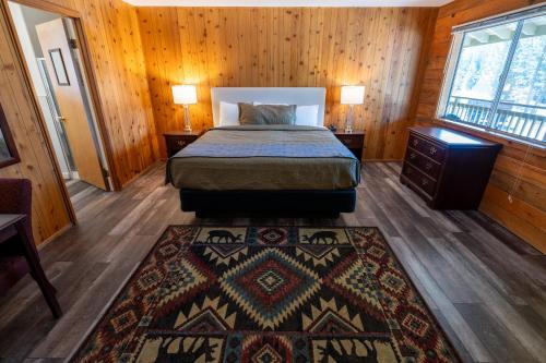 a bedroom with a bed and a rug on the floor at The Tamarack Lodge in Lakeshore