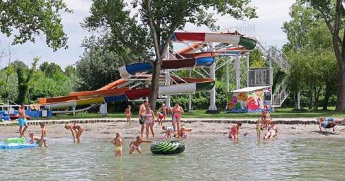 a group of people in the water at a water park at Studios near Beach in Balatonfoeldvar 18525 in Balatonföldvár