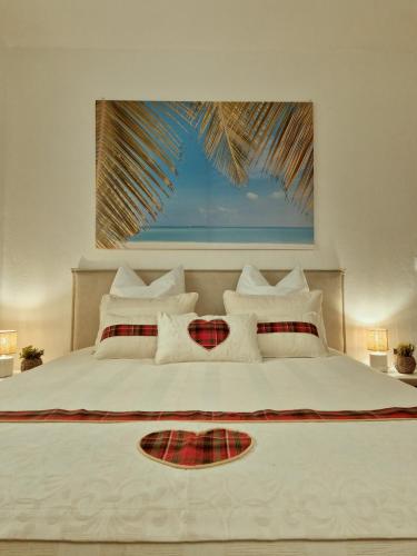 a bedroom with a large white bed with a window at Vi la dous Kreyol in Sainte-Rose