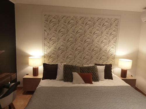 a bedroom with a large bed with two lamps at Casa do beco Martinho in Viana do Castelo