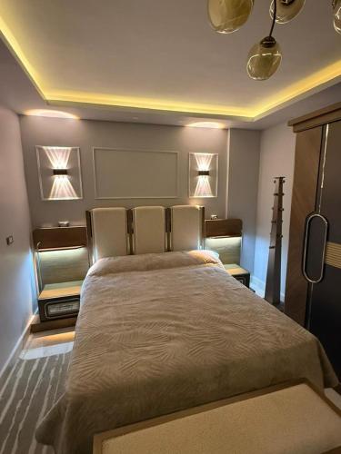a bedroom with a large bed with lights on it at Duplex villa in Beverly Hills in Sheikh Zayed