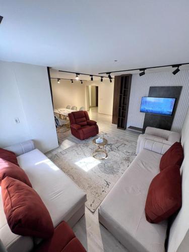 a living room with couches and a couch and a table at Duplex villa in Beverly Hills in Sheikh Zayed