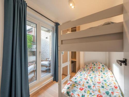 a bedroom with a bunk bed and a window at Knokke City Centre Apartment for 6 in Knokke-Heist
