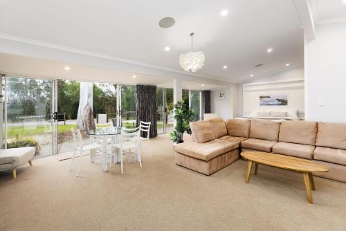 a living room with a couch and a table at BIG4 Noosa North Shore in Noosa North Shore