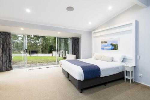a bedroom with a large bed and a large window at BIG4 Noosa North Shore in Noosa North Shore