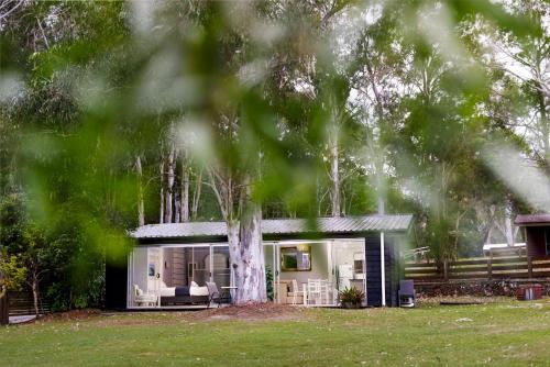 a house with a tree in front of it at BIG4 Noosa North Shore in Noosa North Shore