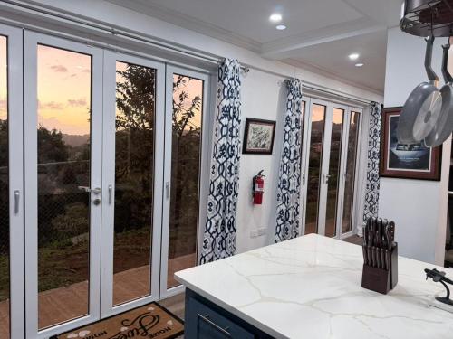 a kitchen with sliding glass doors with a view at The House Next Door in Calliaqua