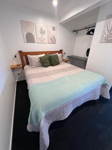 a bedroom with a large bed in a room at TAT's Place in Coopers Beach