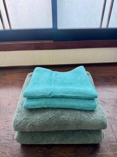 a stack of towels sitting on top of a floor at ANFT-shiro in Azumino