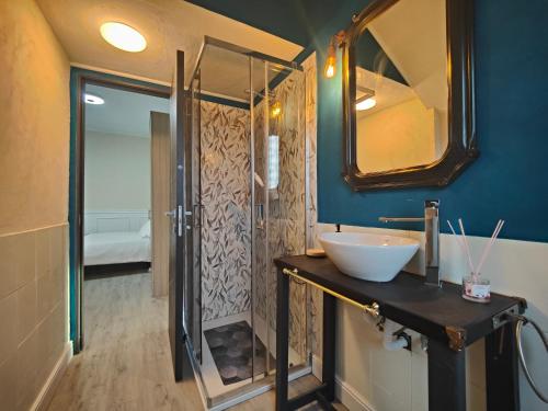a bathroom with a sink and a mirror and a shower at Mini Loft con terrazza vista Alpi in Vinovo
