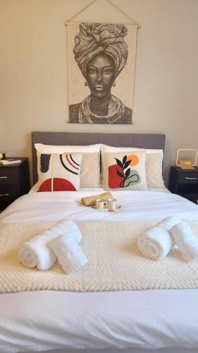 a bed with towels on top of it with a bustrider at Urban Retreat - Leeds City Centre - Sleeps 4 in Central Station