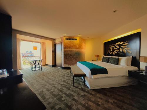 a hotel room with a large bed and a table at Casa del Alma Hotel Boutique & Spa in San Cristóbal de Las Casas