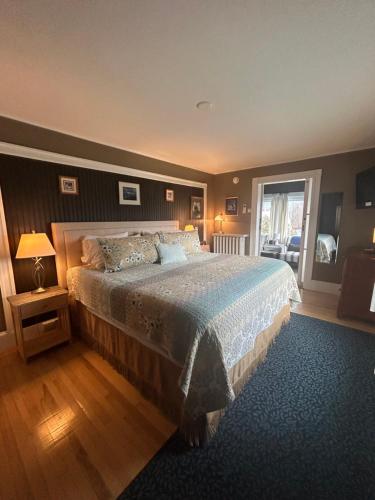 a bedroom with a large bed and a window at Oxford House Inn in Fryeburg