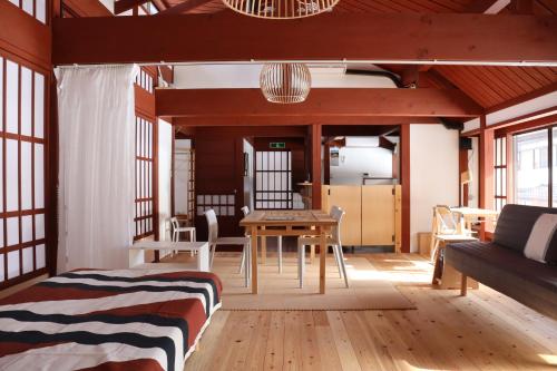 a living room with a bed and a table at Essai B&B - Quiet Village Retreat in Gokayama, near Shirakawa-go in Nanto