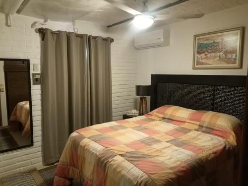 a bedroom with a bed with a colorful blanket at terraza y balcón en la zona romantica cerca del mar in Puerto Vallarta