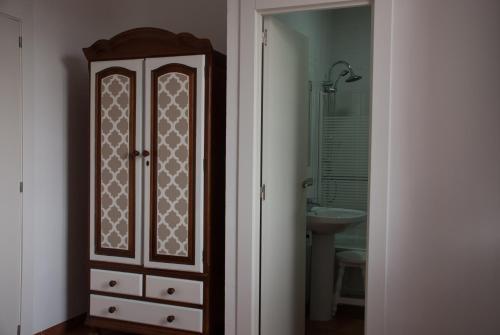 y baño con armario de madera y lavabo. en Hotel - Restaurante Estación Vía Verde, en Olvera