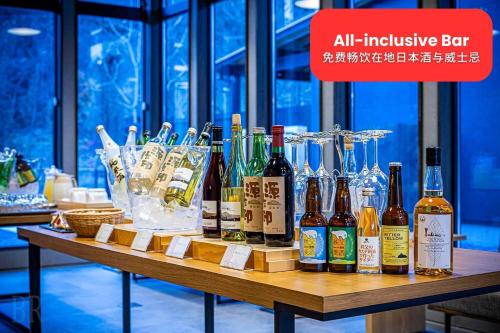 a table full of bottles of wine and glasses at 秩父別邸 木叢 komura in Chichibu
