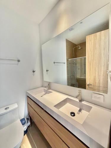 a bathroom with a white sink and a mirror at kristal lagoon view apartement in Cartagena de Indias