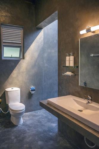 a bathroom with a toilet and a sink at Coco forest camping in Kurunegala