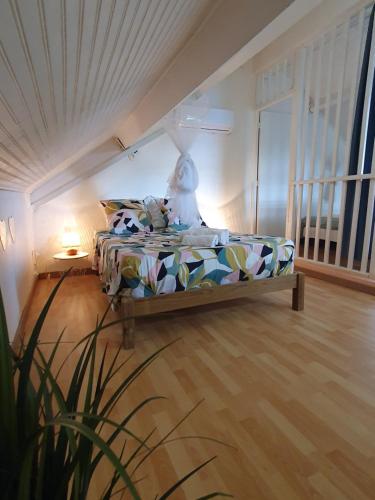 a bedroom with a bed in a room at Duplex cosy avec piscine à 2mn de la plage - Kaz Ti Plaj in Les Trois-Îlets