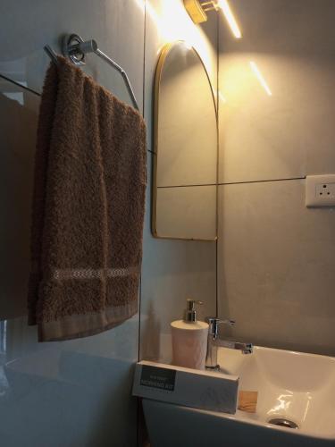 a bathroom with a sink and a mirror at The Fortunara Crown Munnar in Munnar
