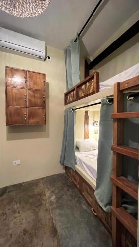 a room with two bunk beds and a window at Ginhawa Stay Mixed dorm 6 Bed in Burgos