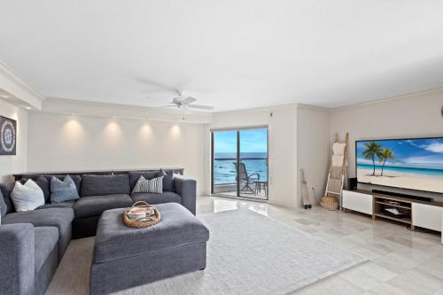 a living room with a couch and a tv at Privateer #601 in Longboat Key