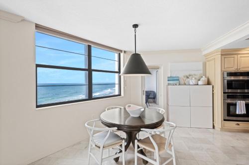 a kitchen with a table and chairs and a window at Privateer #601 in Longboat Key