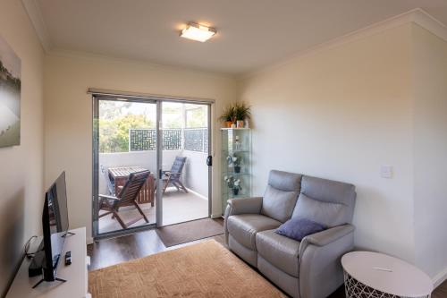 a living room with a couch and a table at Mill View Link in Albany