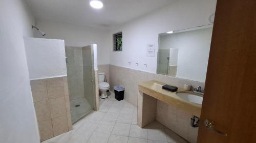 a bathroom with a sink and a shower and a toilet at Residencia COCO 28 con Piscina Downtown Cancun in Cancún