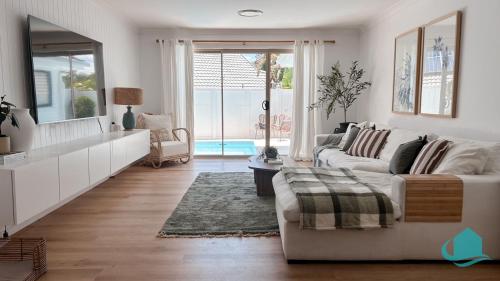a living room with a couch and a table at Summerland Escape in Summerland Point
