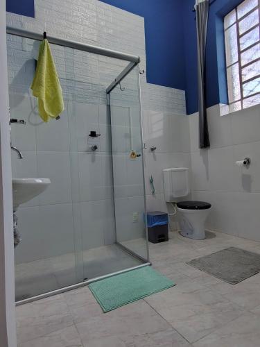 a bathroom with a shower with a sink and a toilet at Loft Cruzeiro in Belo Horizonte