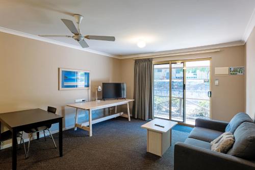 a living room with a couch and a desk and a window at Grandis 35 in Albany