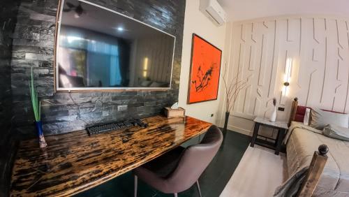 a room with a desk and a bedroom with a bed at The Longhouse Luxury Boutique Resort in Sakon Nakhon