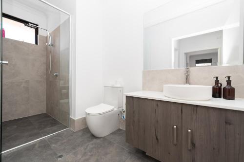 a bathroom with a toilet and a sink and a shower at Winchester Residence in Armadale