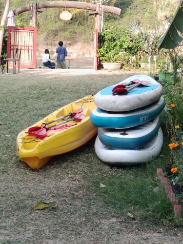 a stack of inflatable kayaks sitting on the grass at Coffee Homestay A Vũ in Kon Cho Dri