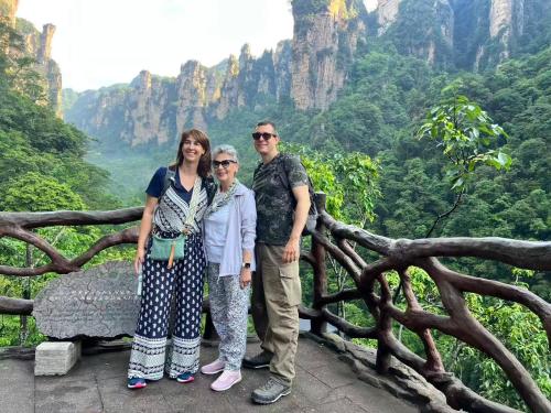 a group of people standing at the top of a mountain at Zhangjiajie Cloudscape Villa - New Hotel, Free Private Car Rides to South & East Gates of Zhangjiajie National Forest Park,Free Private Car Rides to & from Airport,Chinese-Western Breakfast, Coffee, Tea & Fruit, Free Laundry & Dryer, Ticket Guidan in Zhangjiajie