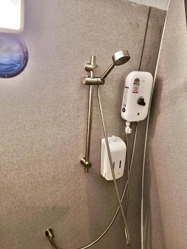 a blow dryer is attached to the wall of a bathroom at Castaway on Mook in Ko Mook