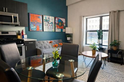 a kitchen and a living room with a glass table at McCormick Place 420 Friendly 3BR in Downtown Chicago with Optional Parking Sleeps 8 Guests Near Soldier Field, Grant Park and Lakefront Trail in Chicago