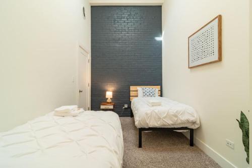 a bedroom with a bed and a chair in it at McCormick Place 420 Friendly 3BR in Downtown Chicago with Optional Parking Sleeps 8 Guests Near Soldier Field, Grant Park and Lakefront Trail in Chicago