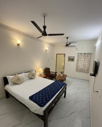 a bedroom with a bed with a ceiling fan at Gravity Groups AARA Residency - Near Jipmer in Puducherry Airpoert