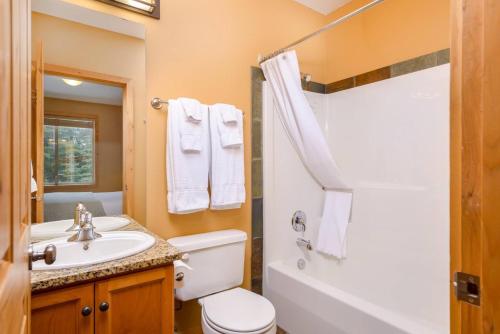a bathroom with a white toilet and a sink at Best Ski-in out 3 Bdrm Chalet, with Hot Tub in Big White