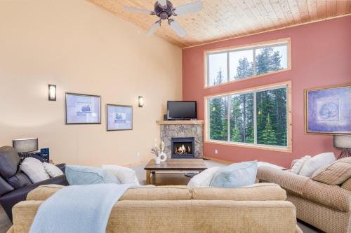 a living room with two couches and a fireplace at Best Ski-in out 3 Bdrm Chalet, with Hot Tub in Big White
