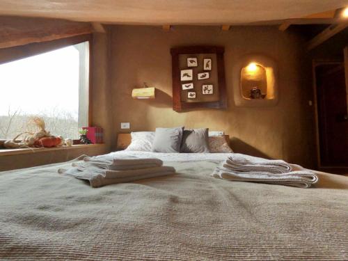 a bedroom with a bed with towels on it at Šumska 1 - Fruška gora in Sremska Kamenica