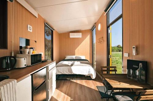 a bedroom with a bed in a tiny house at Little Haven Cottage X by Tiny Away in Balliang