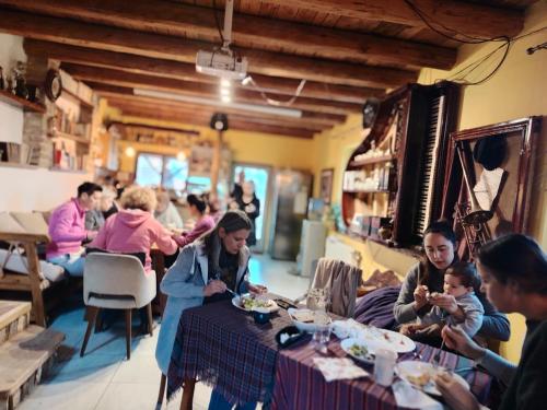 a group of people sitting at tables in a restaurant at Šumska 1 - Fruška gora in Sremska Kamenica