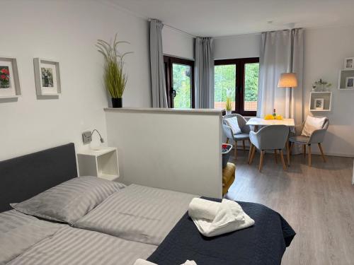 a bedroom with a bed and a dining room at Seeblick Labud 20 Bosau in Bosau