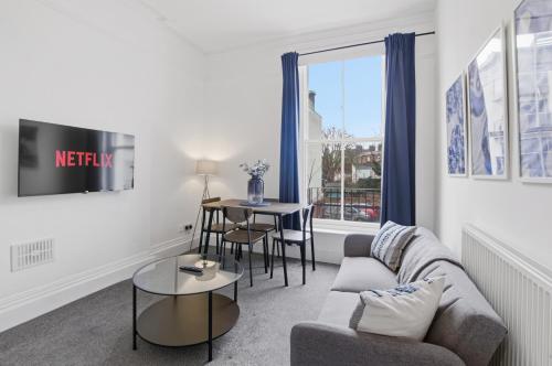 a living room with a couch and a table at Modern Serviced Apartments Steps From Gloucester Quays in Gloucester