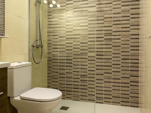 a bathroom with a toilet and a shower at Maspalomas Green Oasis 1404 in Maspalomas